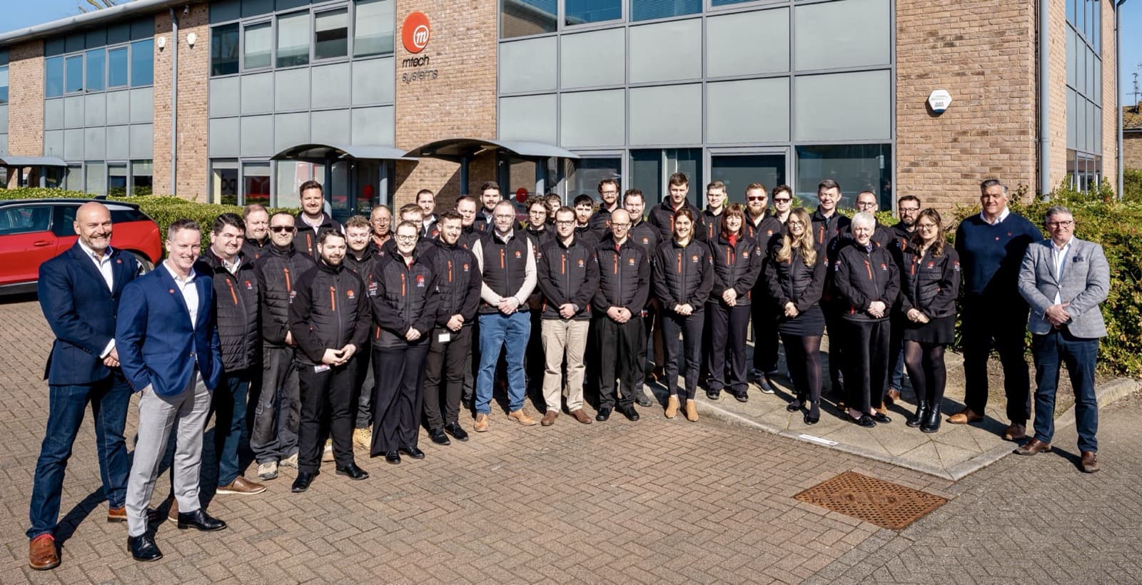 The M-Tech team gathered outside the Eastbourne office, 2023.